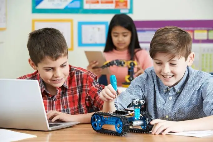 A group of kids playing with an interactive robot.